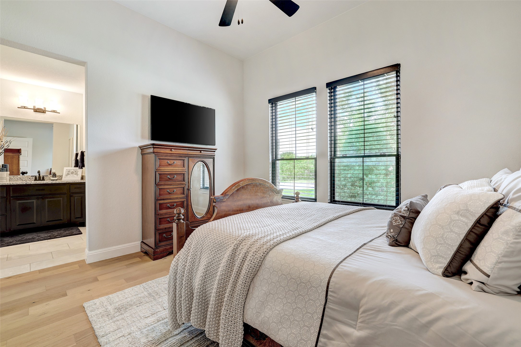 400 Flint Ridge Trail Georgetown, TX 78628 - Photo 20 of 40 Bedroom with light wood floors, connected bathroom, and ceiling fan