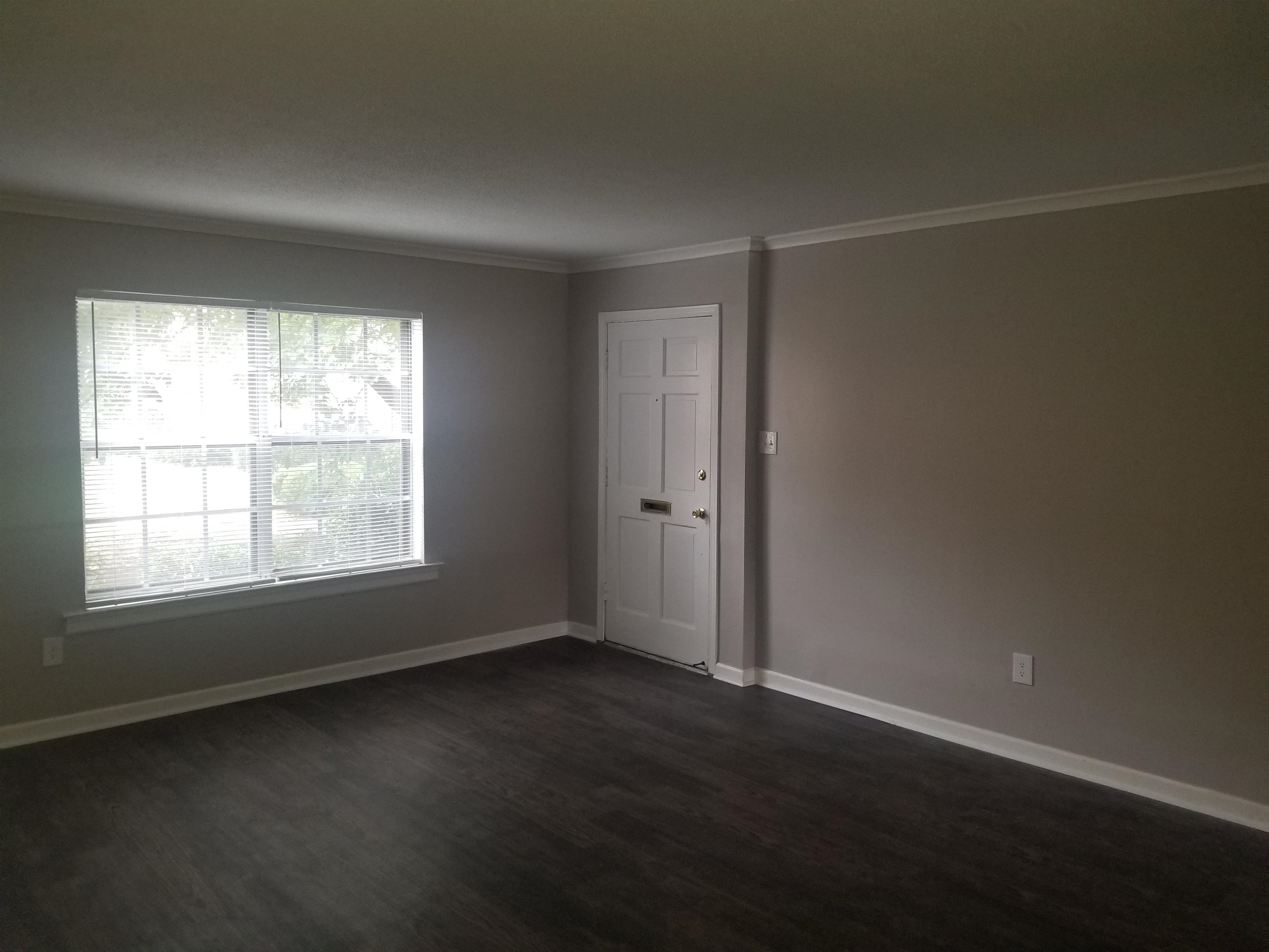 3212 13 Colony Mall, Unit 3A Memphis, TN 38115 - Photo 2 of 5 an empty room with wooden floor and windows