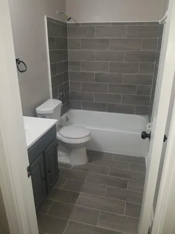 a bathroom with a toilet a sink and bathtub