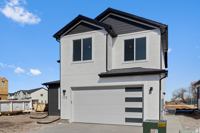 248 West 2920th Street South Logan, UT 84321 - Photo 3 of 47 Contemporary exterior with a white stucco finish and contrasting dark siding
