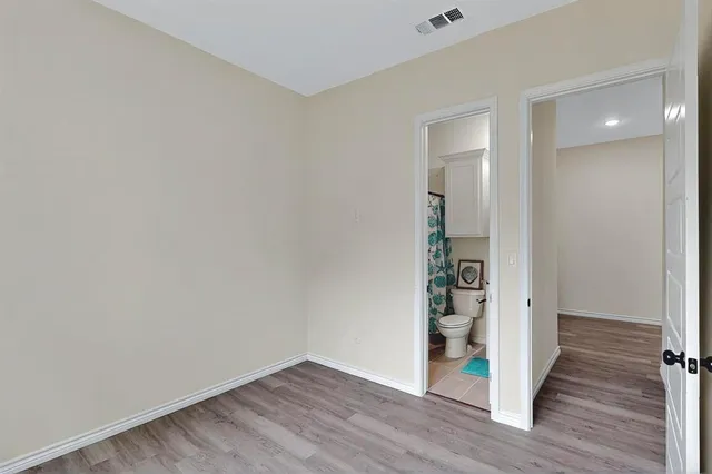 wooden floor in a hall with an empty room and wooden floor