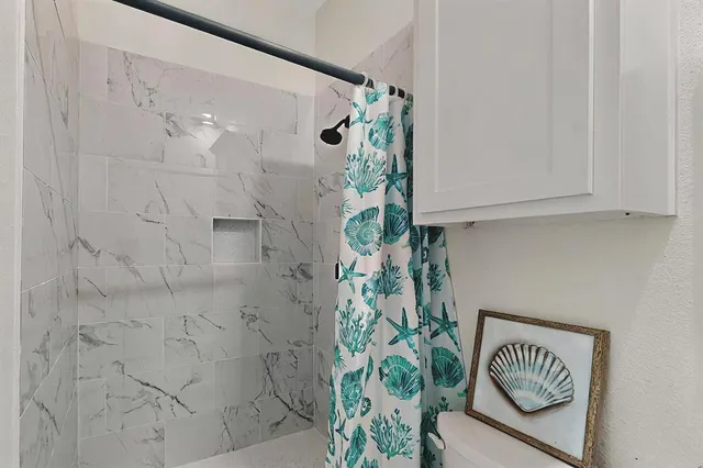 a bathroom with a bathtub and a shower