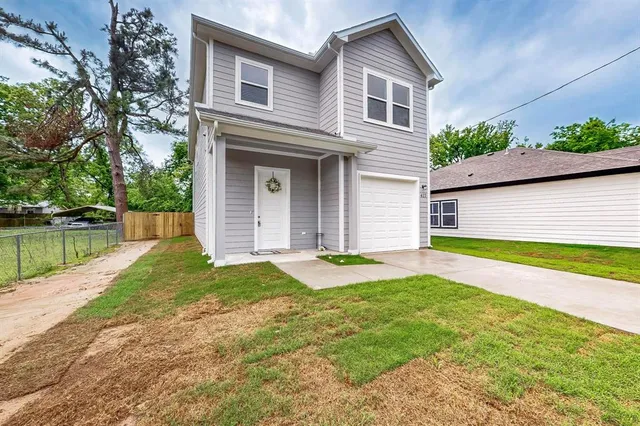 a backyard of a house with plants and lake view