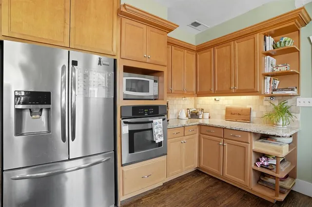 a kitchen with stainless steel appliances a refrigerator sink and cabinets