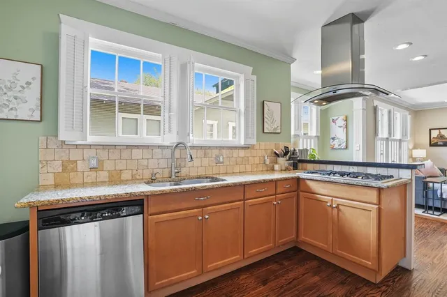 a kitchen with a sink stove and cabinets