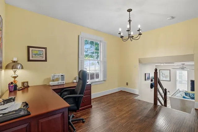 a view of a workspace with furniture and a window