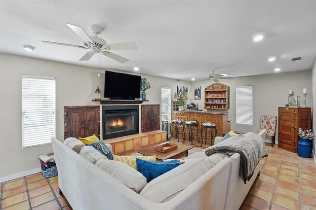 a living room with furniture a flat screen tv and a fireplace