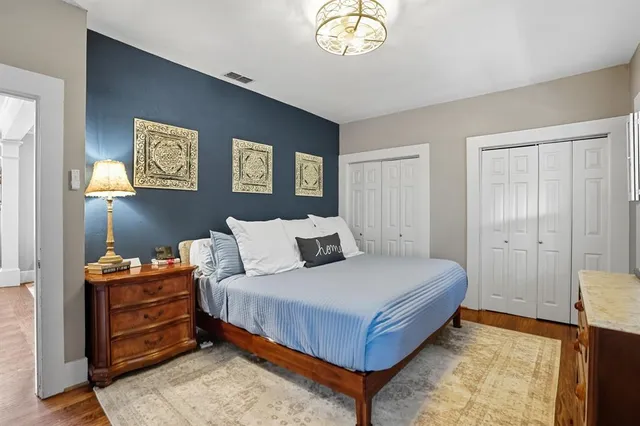 a bedroom with a bed and a chandelier