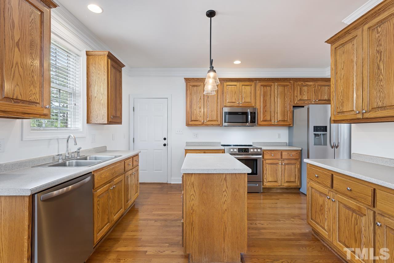 65 Bess Lane Angier, NC 27501 - Photo 17 of 38 a kitchen with stainless steel appliances granite countertop a sink stove and refrigerator