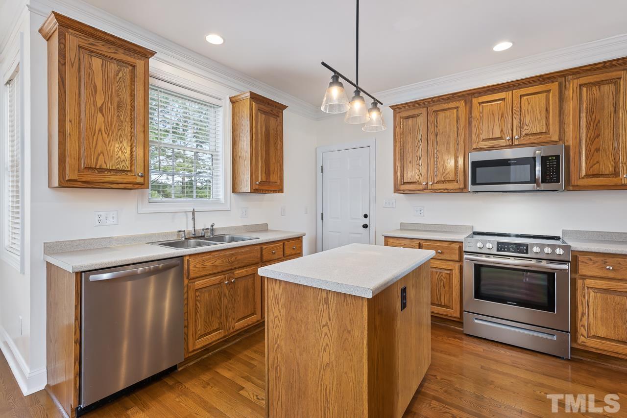 65 Bess Lane Angier, NC 27501 - Photo 18 of 38 a kitchen with stainless steel appliances granite countertop a sink stove and microwave