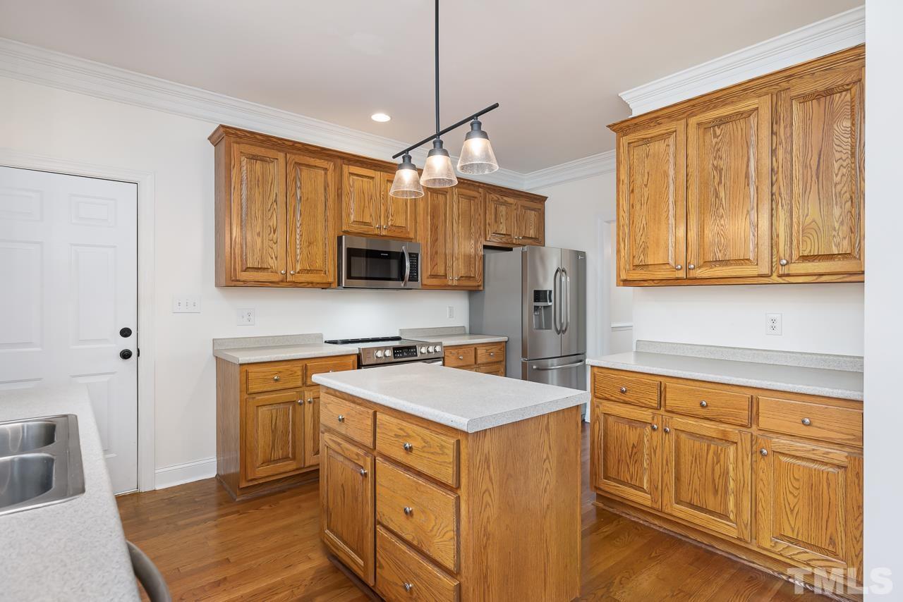 65 Bess Lane Angier, NC 27501 - Photo 19 of 38 a kitchen with white cabinets and white appliances