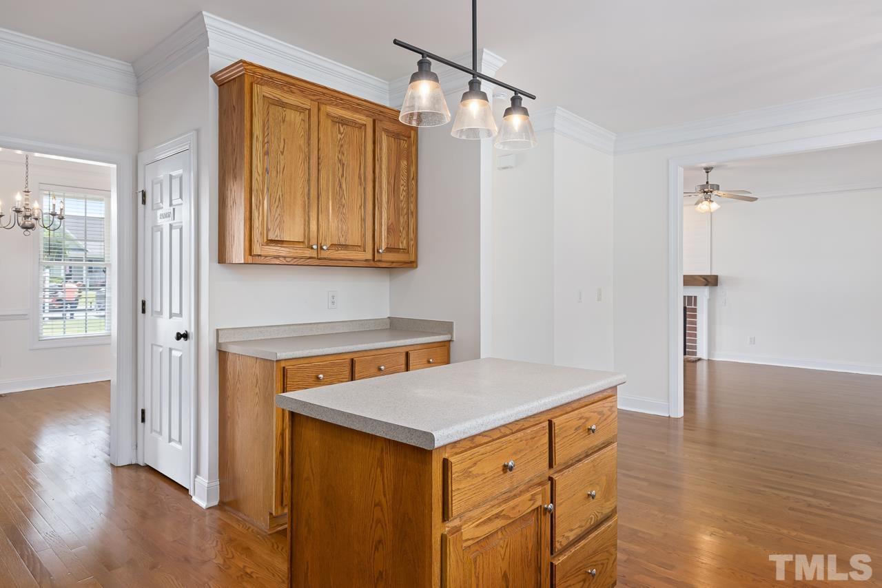 65 Bess Lane Angier, NC 27501 - Photo 20 of 38 a kitchen that has a fridge and a wooden floor