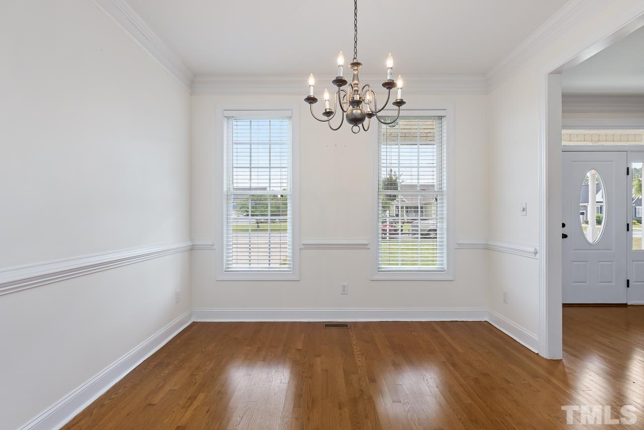 65 Bess Lane Angier, NC 27501 - Photo 22 of 38 a view of an empty room with wooden floor and a window