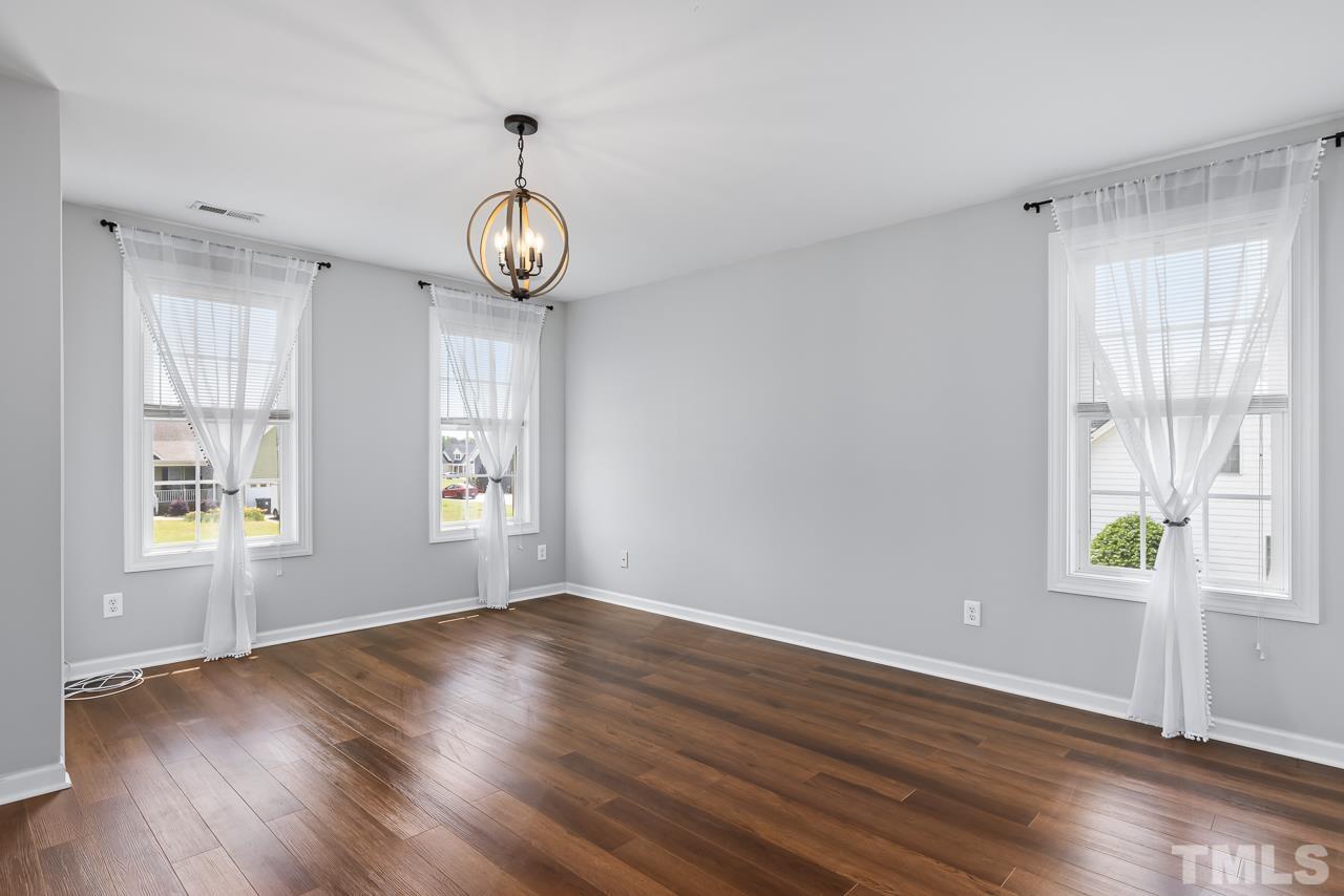 65 Bess Lane Angier, NC 27501 - Photo 24 of 38 a view of an empty room with wooden floor and a window