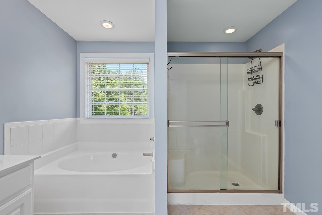 65 Bess Lane Angier, NC 27501 - Photo 27 of 38 a bathroom with a bathtub and a shower