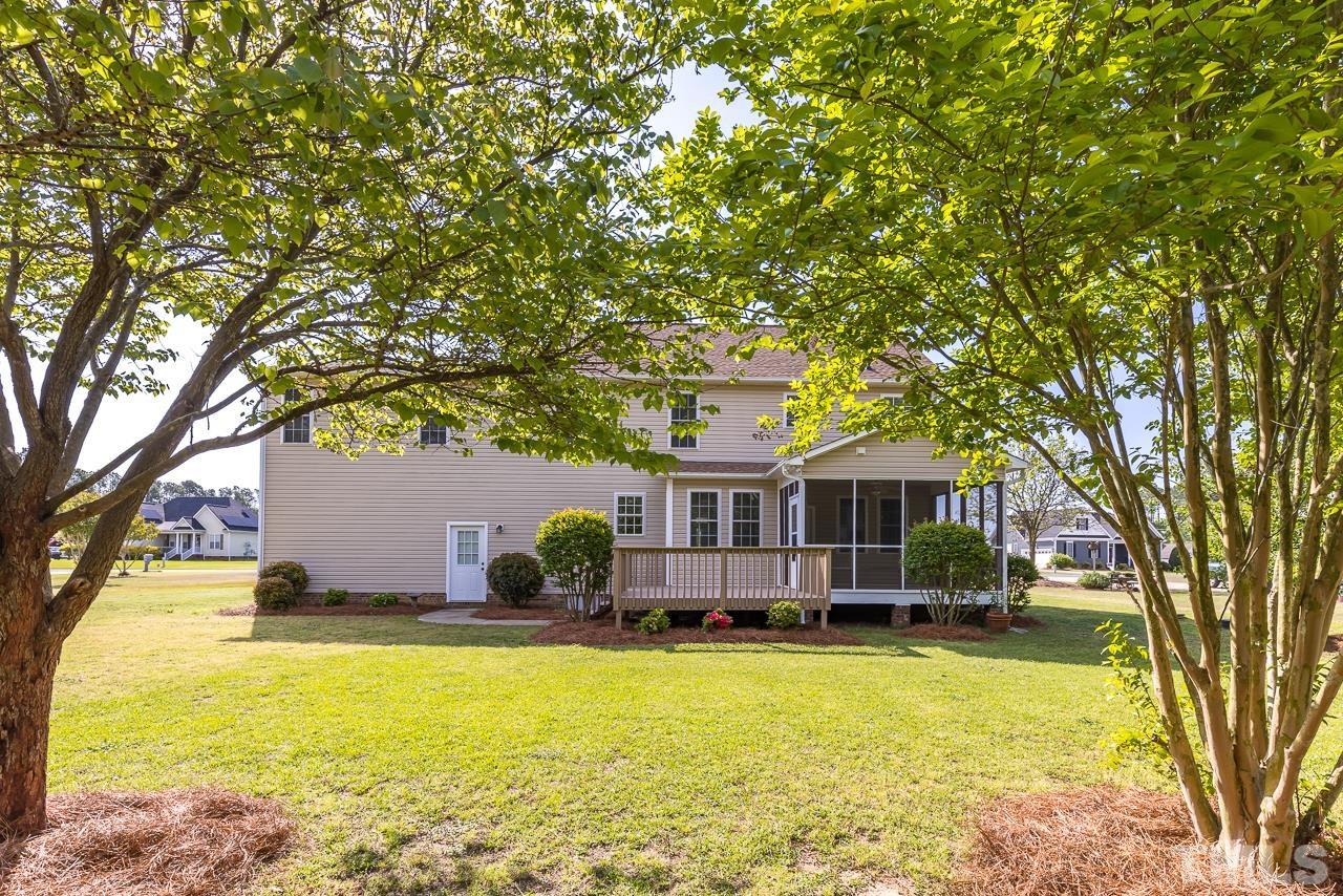 65 Bess Lane Angier, NC 27501 - Photo 3 of 38 a front view of a house with swimming pool and porch