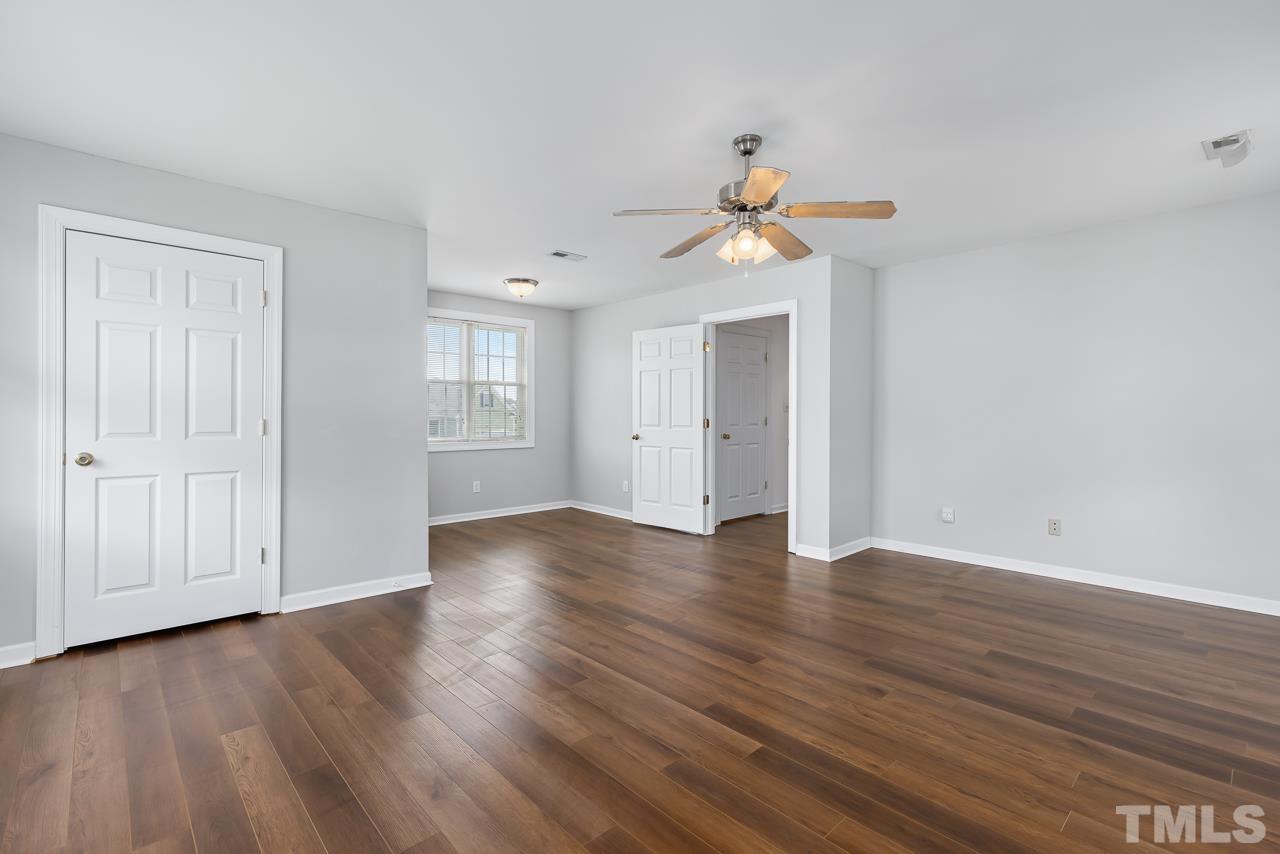 65 Bess Lane Angier, NC 27501 - Photo 33 of 38 a view of an empty room with window and wooden floor