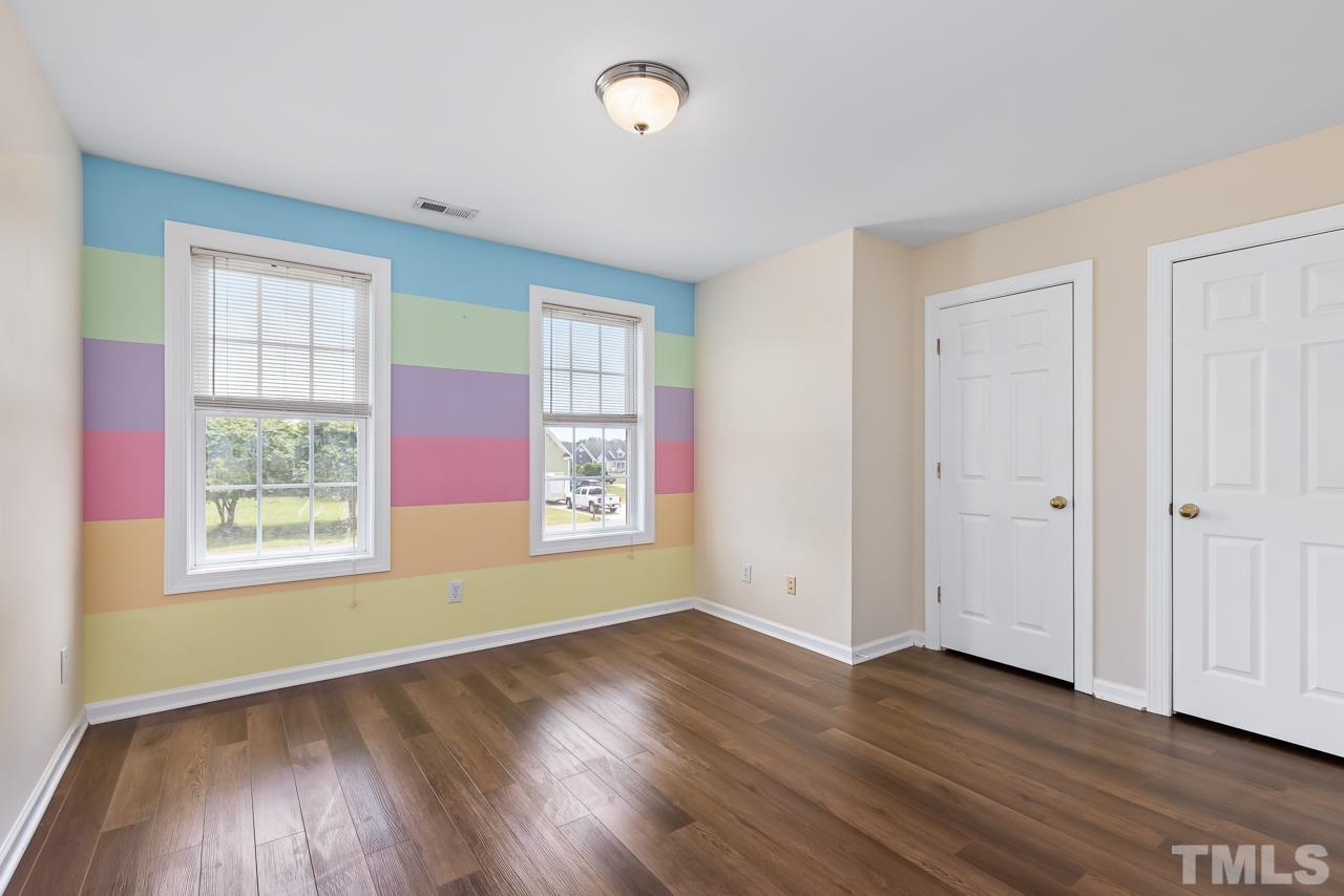65 Bess Lane Angier, NC 27501 - Photo 34 of 38 an empty room with wooden floor and windows
