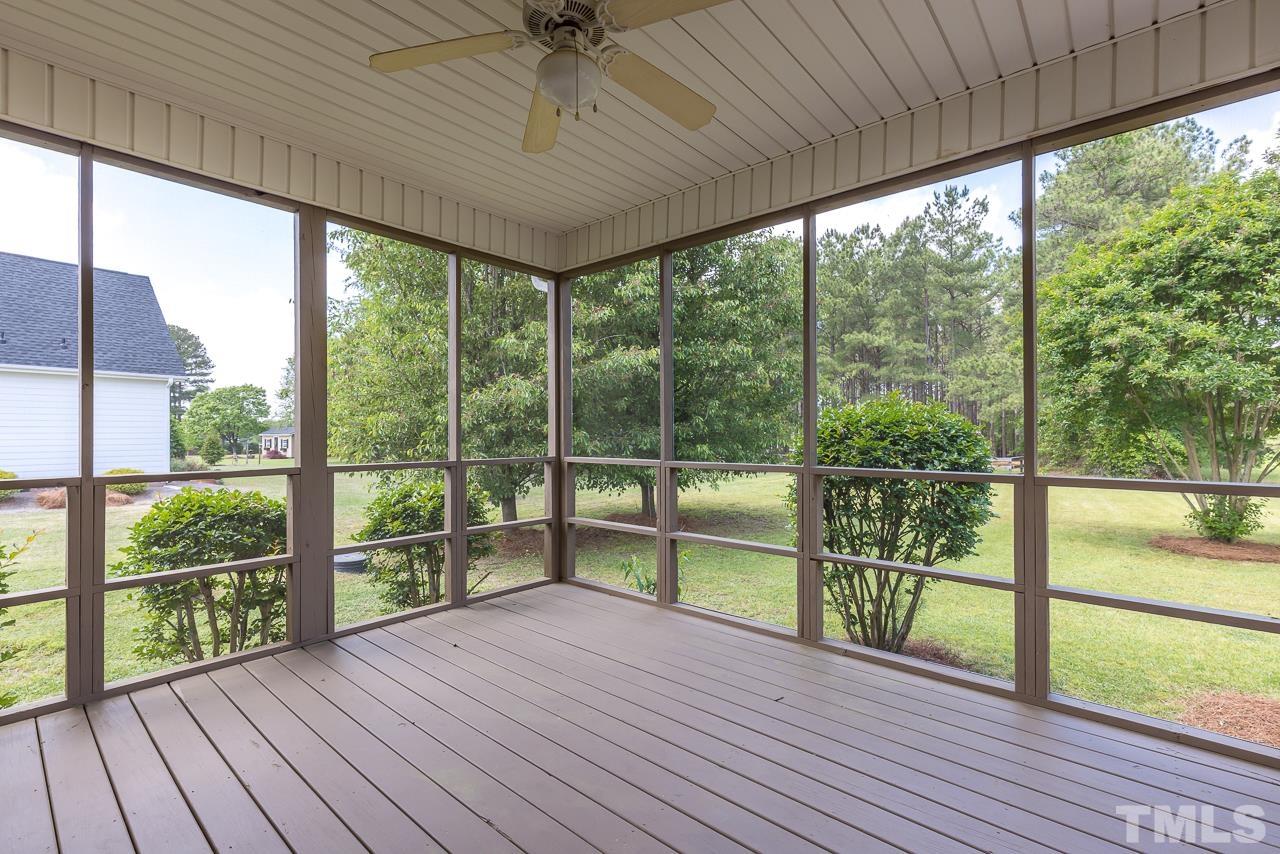 65 Bess Lane Angier, NC 27501 - Photo 35 of 38 a view of a room with wooden floor and balcony next to a yard