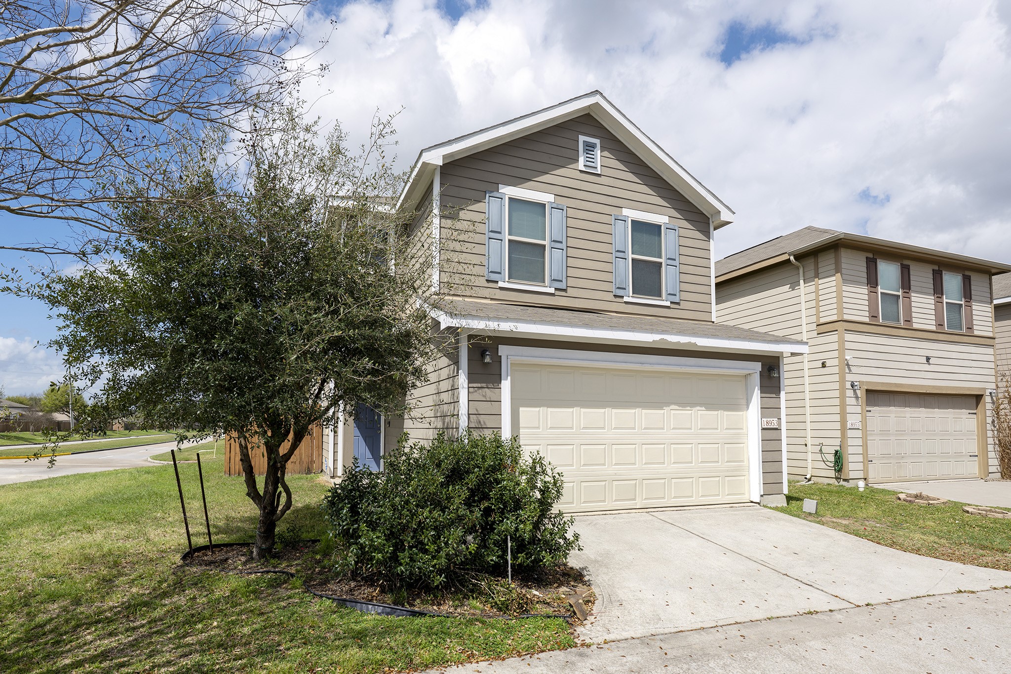 18953 Bobcat Path Houston, TX 77073 - Photo 1 of 21 a front view of a house with a yard and trees