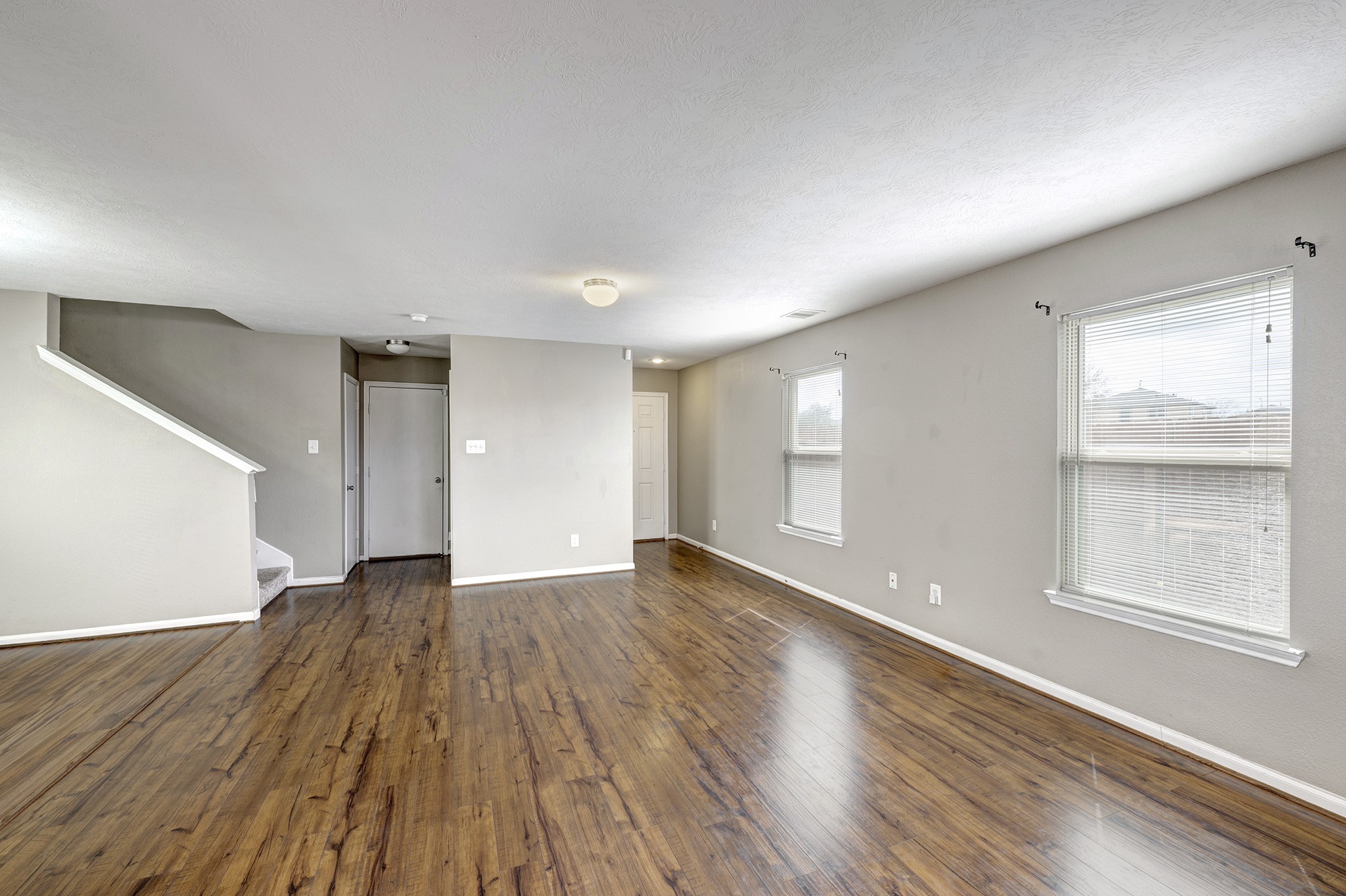18953 Bobcat Path Houston, TX 77073 - Photo 4 of 21 an empty room with wooden floor and windows