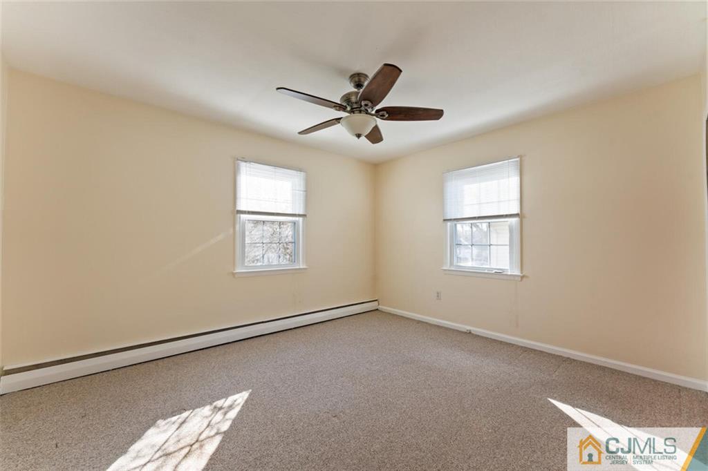 68 Middle Hill Road Colonia, NJ 07067 - Photo 12 of 33 a view of a big room with windows and chandelier fan
