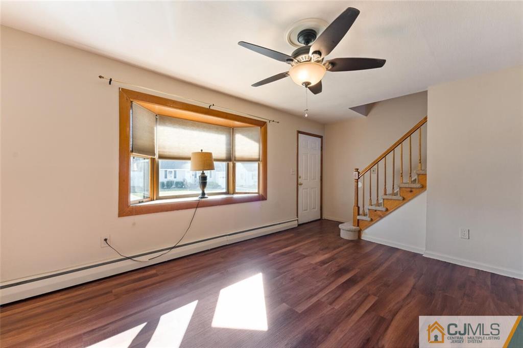 68 Middle Hill Road Colonia, NJ 07067 - Photo 6 of 33 a view of an empty room with wooden floor and a window