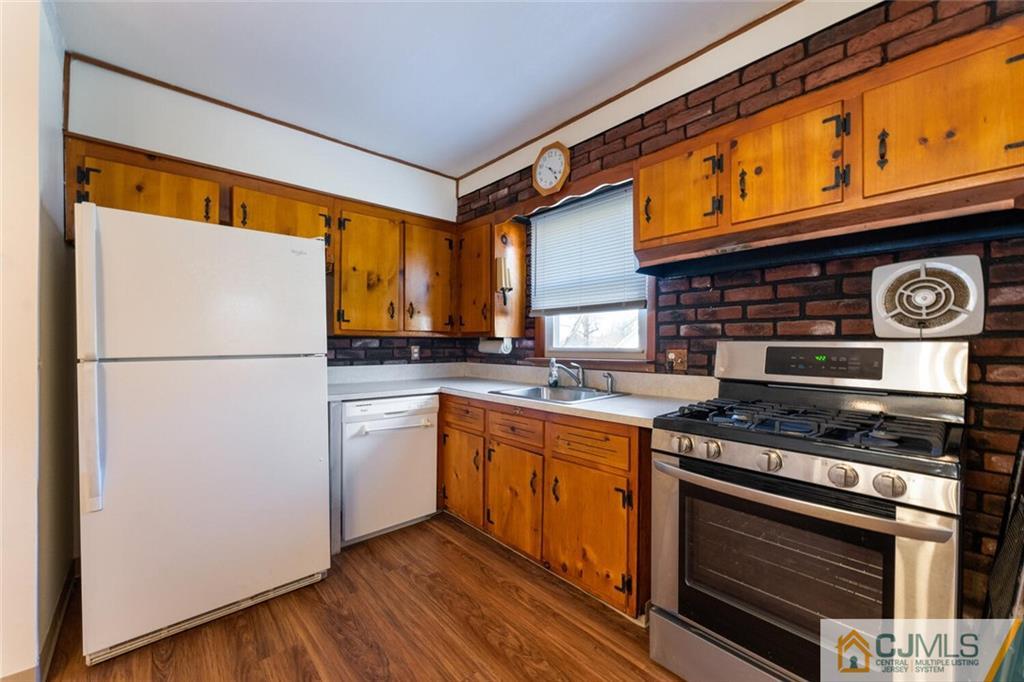 68 Middle Hill Road Colonia, NJ 07067 - Photo 10 of 33 a kitchen with stainless steel appliances granite countertop a stove a refrigerator and a microwave