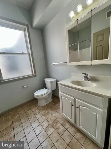 a bathroom with a toilet a window and a shower