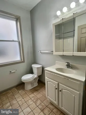 a bathroom with a toilet a sink and a shower