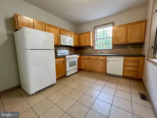 a kitchen with a stove a sink and a refrigerator