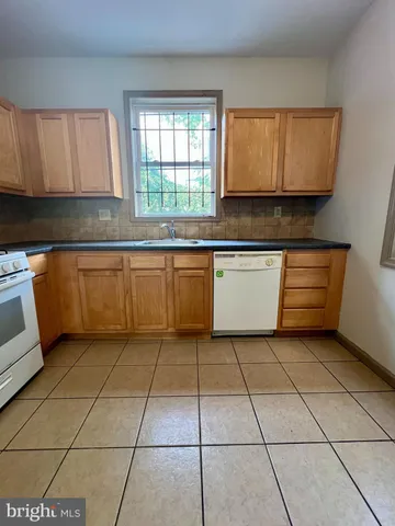 a bathroom with a sink toilet and window
