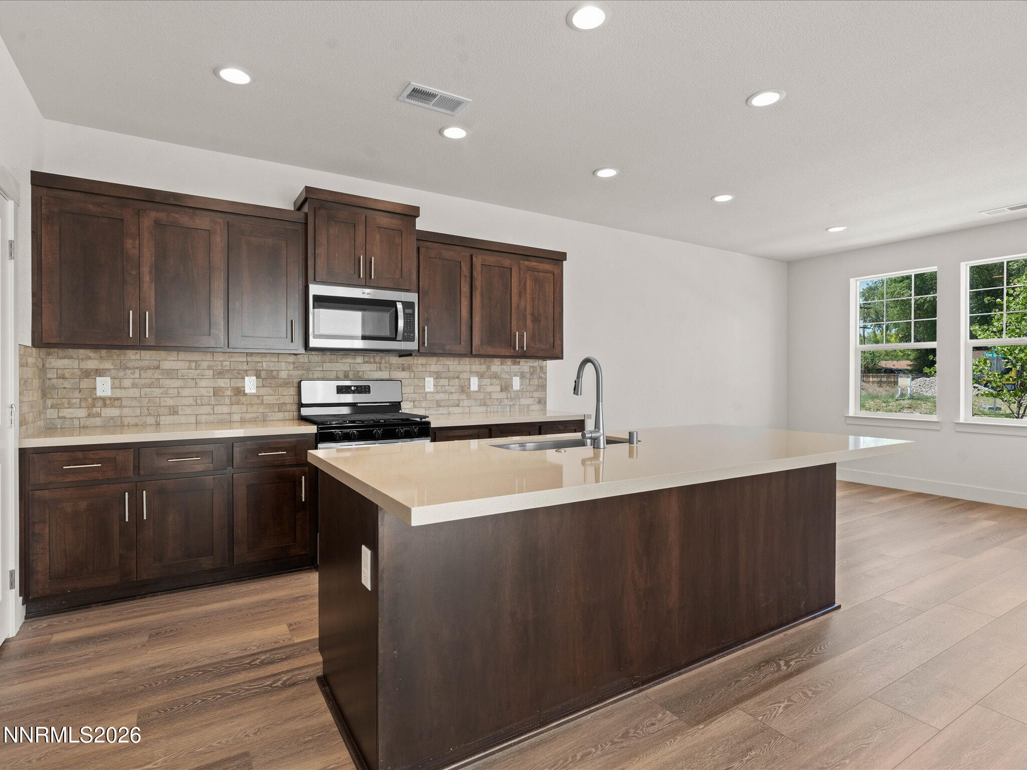 1371 Vine Gate Road, Unit HOMESITE 49 Carson City, NV 89701 - Photo 4 of 24 a kitchen with a stove a sink and a microwave