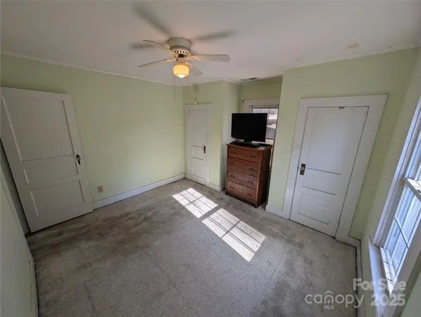 a view of empty room with window and fireplace