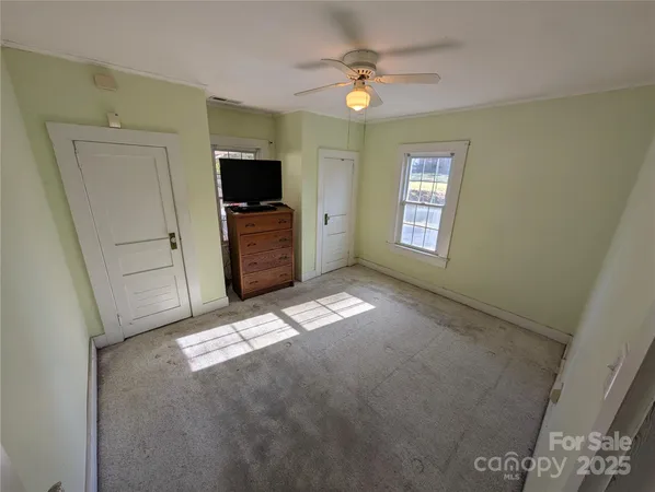 a view of empty room with window and fireplace