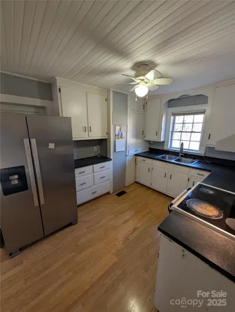 a kitchen with granite countertop a stove and a refrigerator