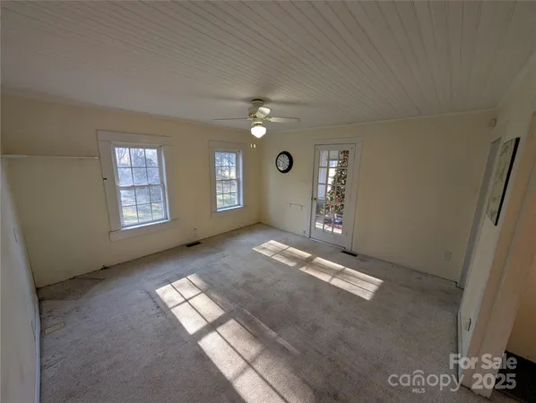 an empty room with windows and closet