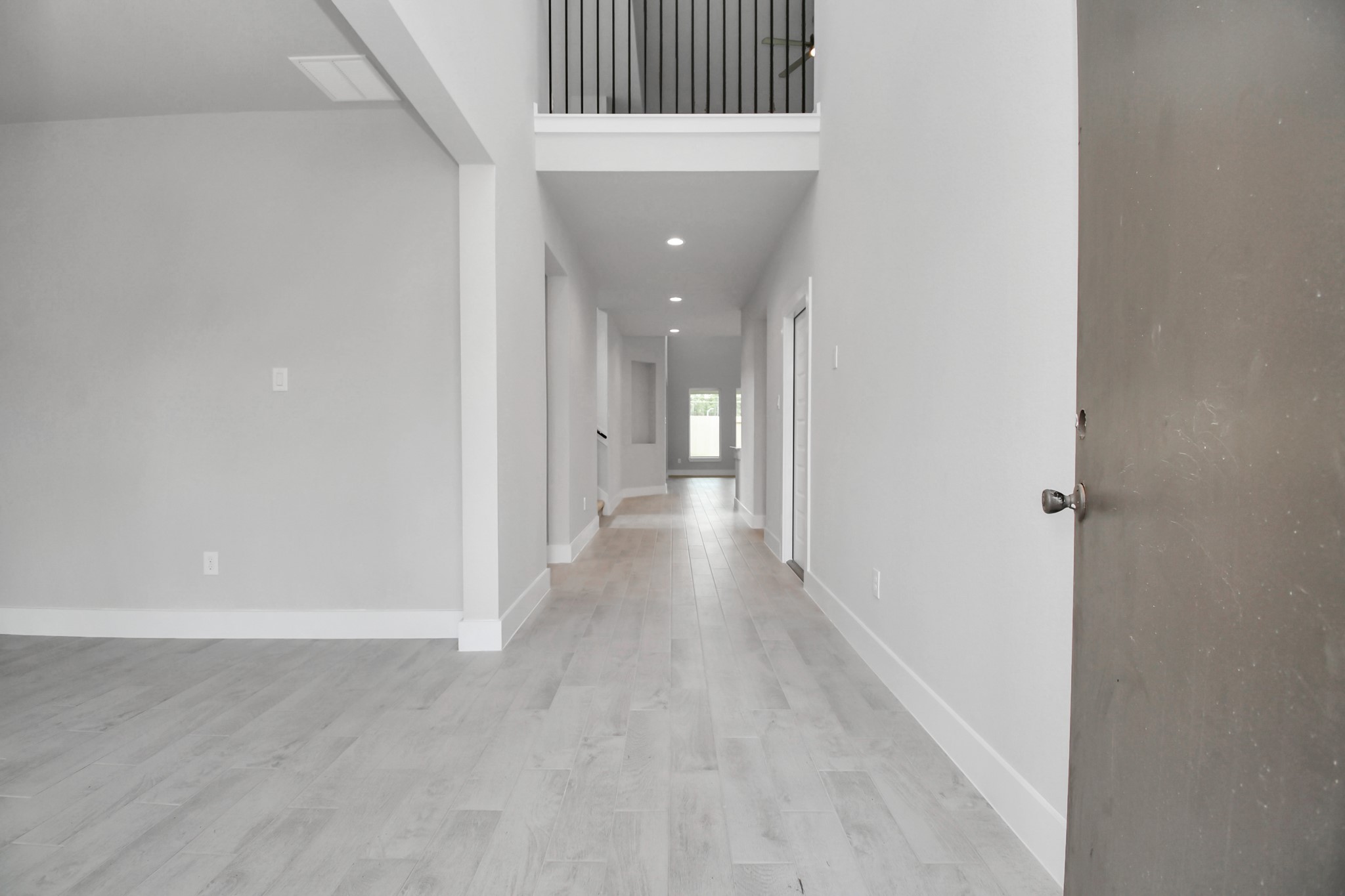 3043 Native Spg Drive Spring, TX 77373 - Photo 6 of 39 As you step into the threshold of this luxurious home, you'll soon be welcomed by an elegant glass door (to be installed). Inside, soaring ceilings amplify the spaciousness, while the refined wood-look tile flooring and oversized baseboards exude sophistication and charm. Sample photo of completed home with similar floor plan. Actual colors and selections may vary.