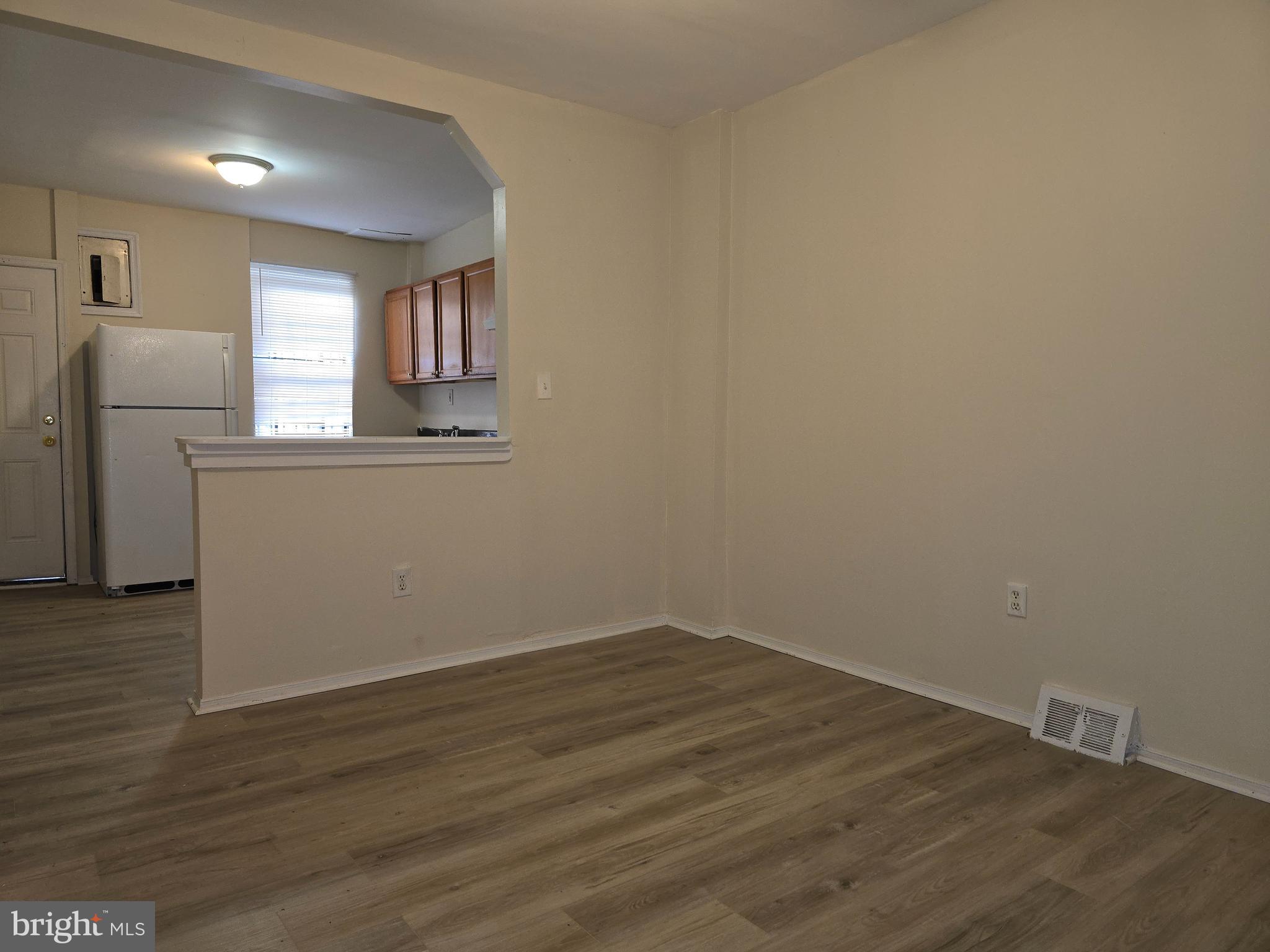 340 South Woodyear Street Baltimore, MD 21223 - Photo 4 of 19 a view of a kitchen with wooden floor and a window
