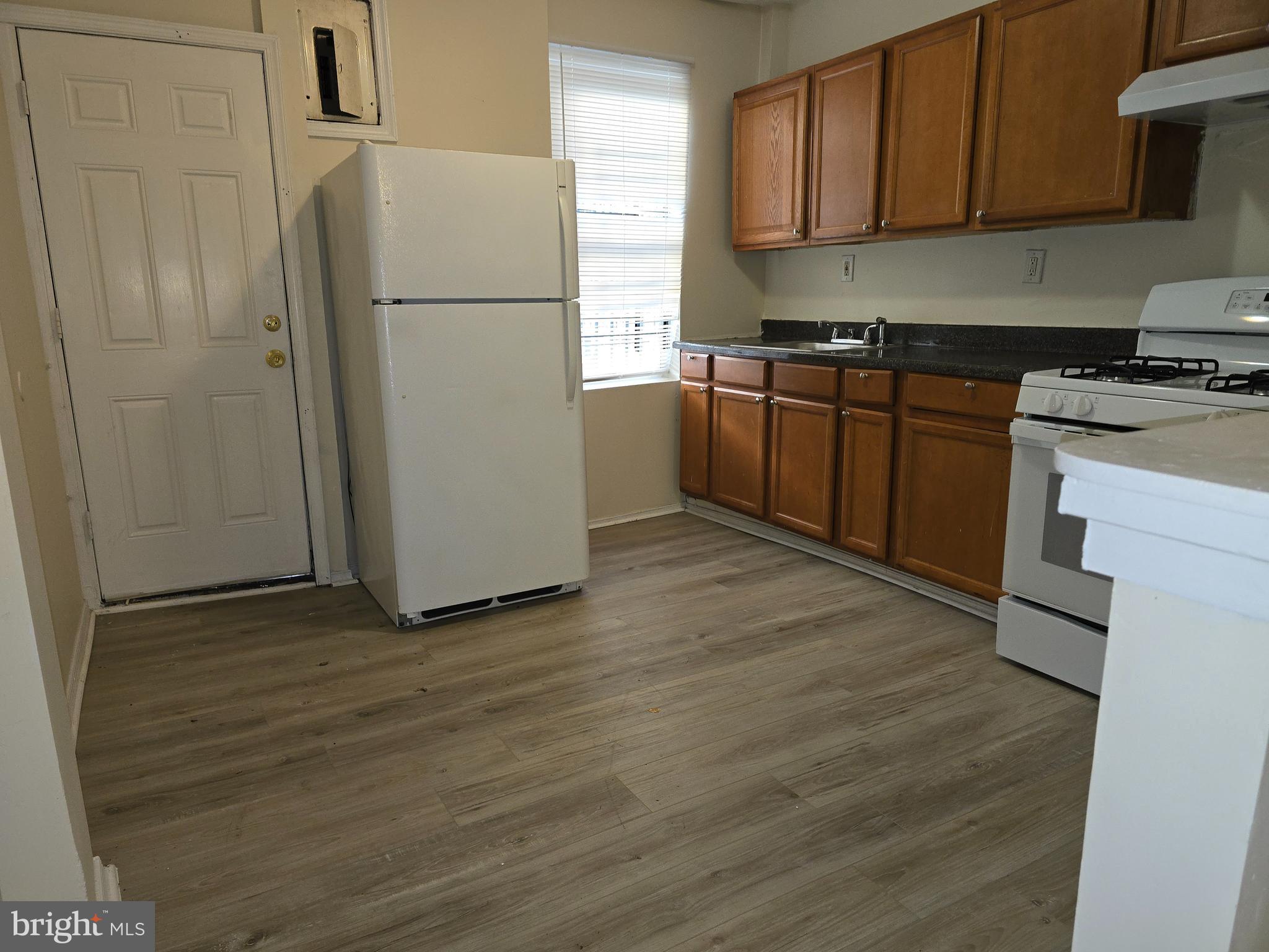340 South Woodyear Street Baltimore, MD 21223 - Photo 5 of 19 a kitchen with stainless steel appliances granite countertop a refrigerator sink and cabinets