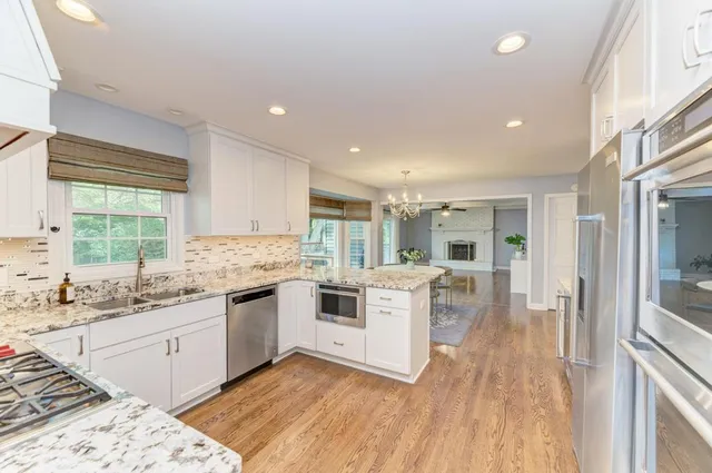 a kitchen with stainless steel appliances granite countertop a stove and cabinets