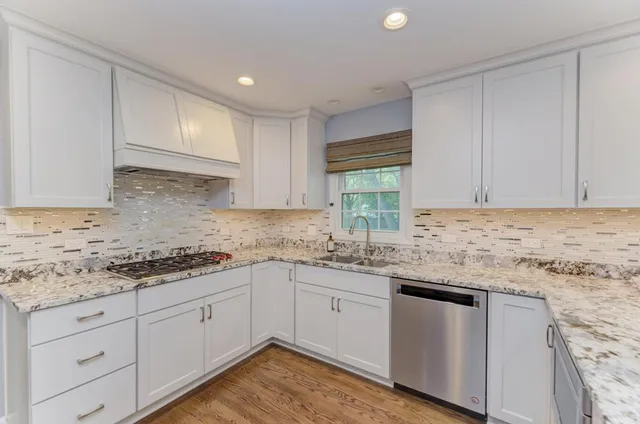 a kitchen with granite countertop cabinets sink and cabinets