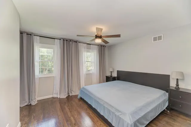 a bedroom with a large bed and a chandelier