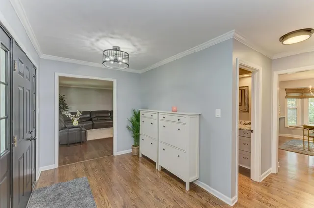 a view of a hallway and dining room with wooden floor