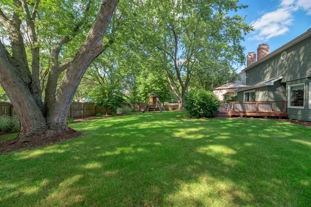 a view of an house with backyard space and balcony