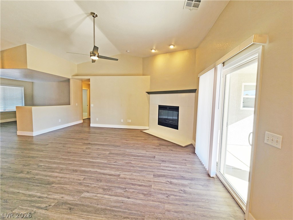 4591 Stoneham Street Pahrump, NV 89061 - Photo 12 of 42 Vast main living space with vaulted ceilings and a cozy corner fireplace.