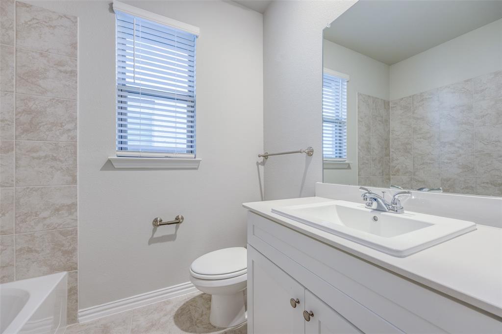 3728 Aqua Lane Sherman, TX 75090 - Photo 10 of 12 a bathroom with a sink a toilet and a window