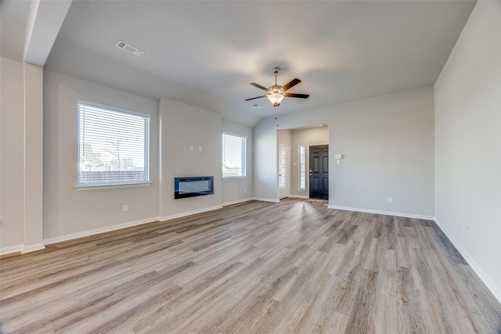 3728 Aqua Lane Sherman, TX 75090 - Photo 3 of 12 a view of an empty room with a window and wooden floor