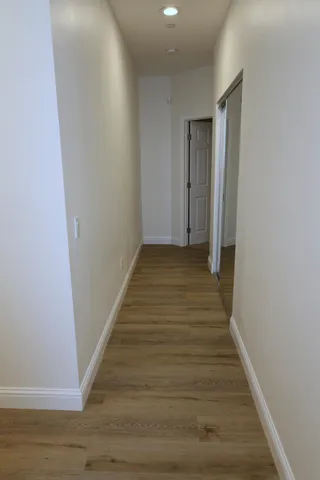 a view of walk in closet with empty racks