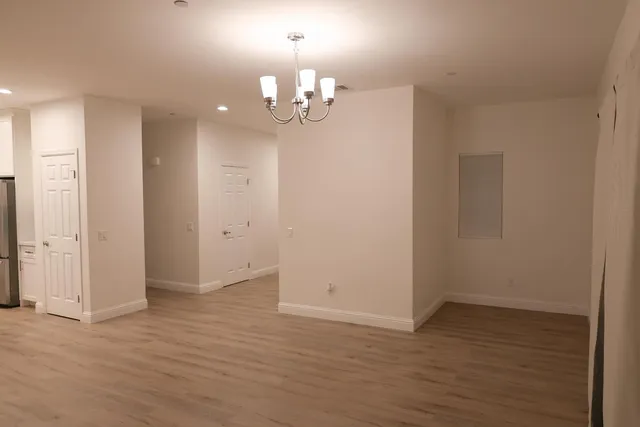 wooden floor in an empty room with a mirror